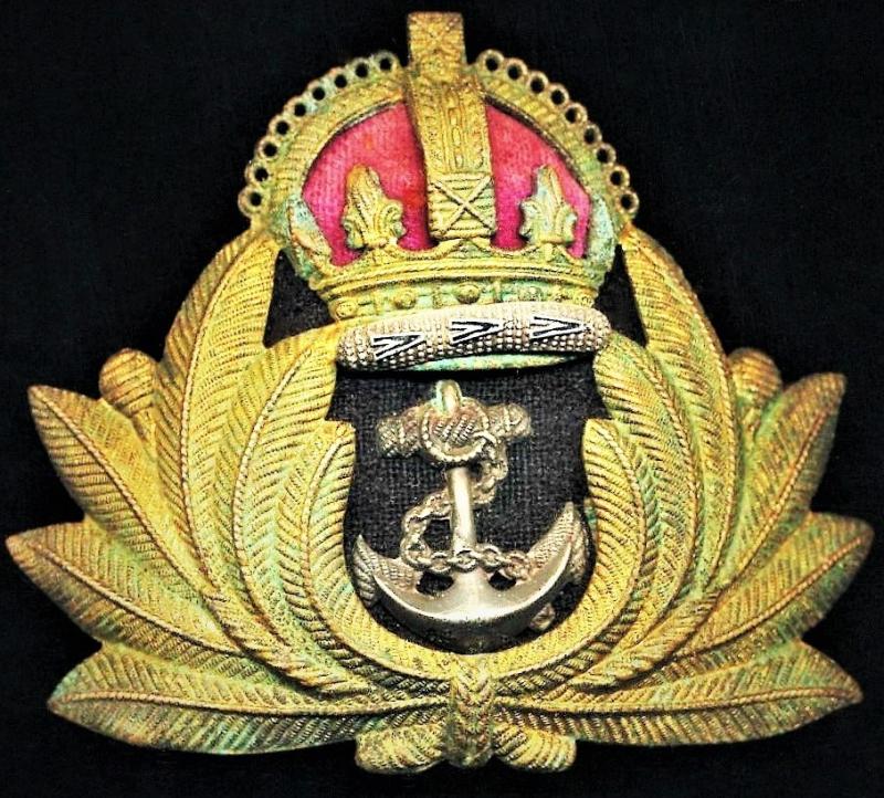 Royal Navy: Naval Officers cap badge with King's Crown, with fabric inserts and pressed gilt metal laurel wreath, on a cloth backed buckram backing & as-worn circa 1918-1945 (World Wars & Korean War)