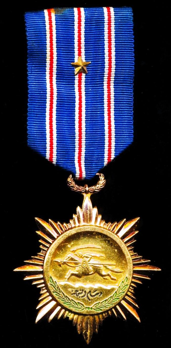 Syria: Order of Bravery. 2nd Class award with 'Silver' star emblem on riband. Gilt and enamel