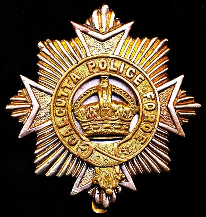 British India: Calcutta Police Force. Bi-metal helmet badge. Kings Crown (of pattern worn 1901-1949)